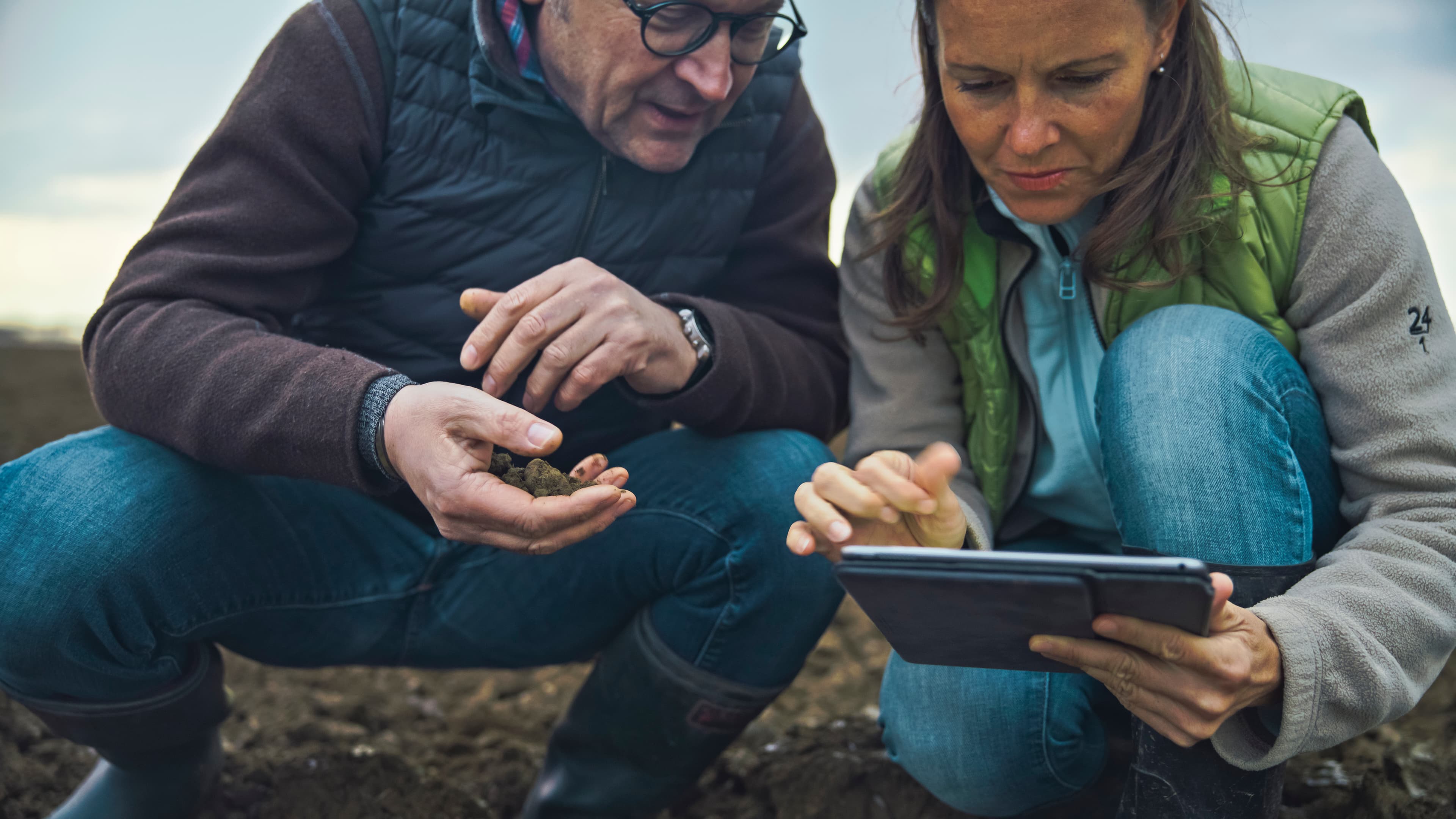 Farmers examining soil together in Wayne County
